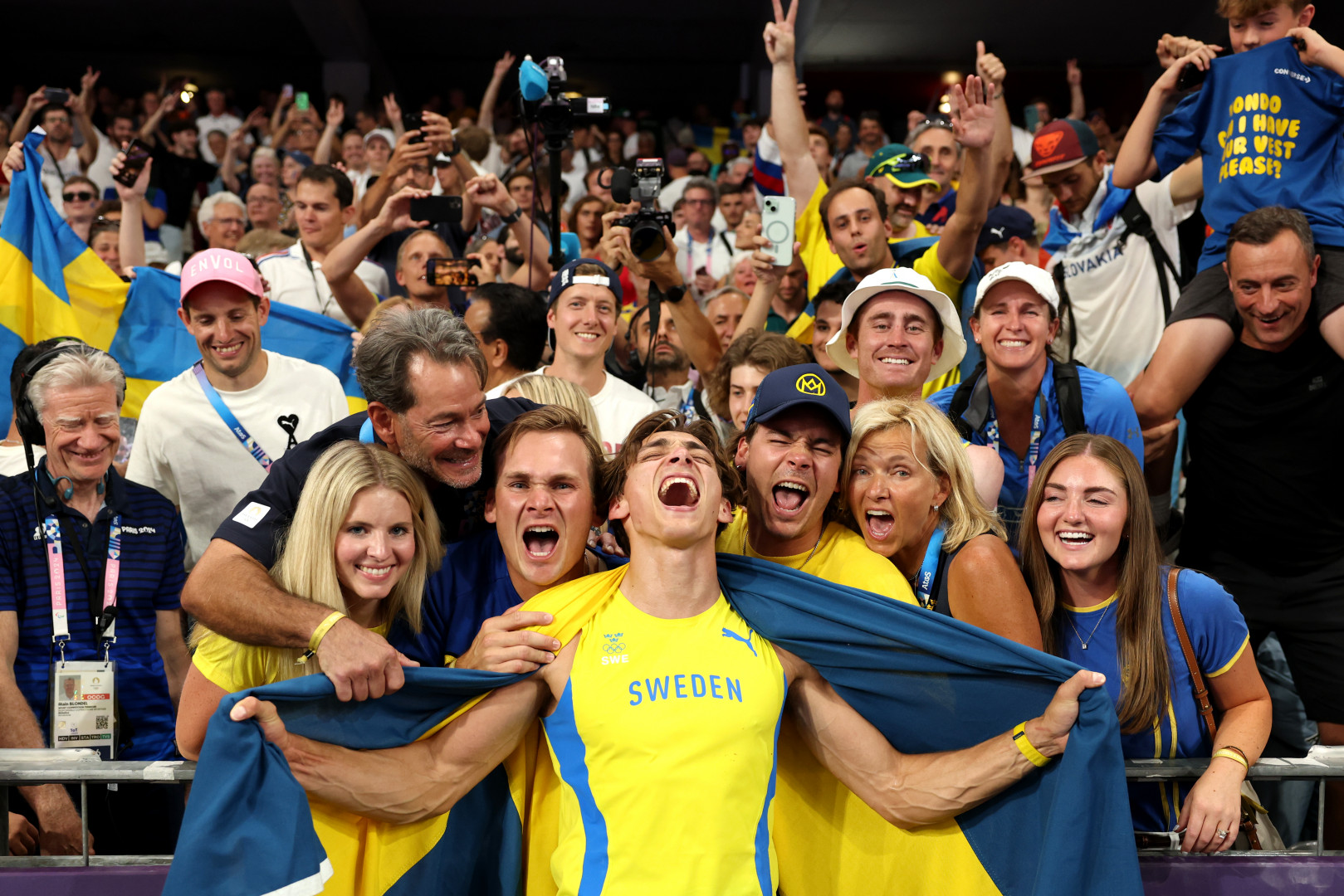 Armand Duplantis of Sweden celebrates his world record-breaking pole vault win at the Paris 2024 Olympics with family and friends.