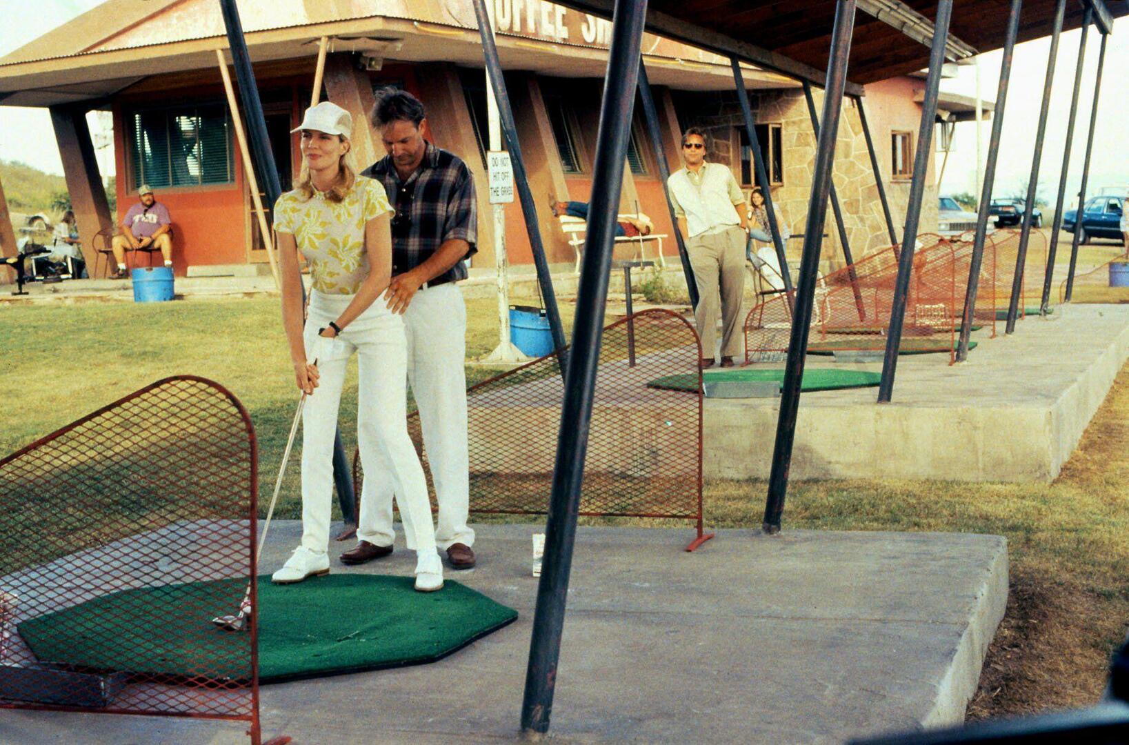 Rene Russo, Kevin Costner, and Don Johnson on a golf course.