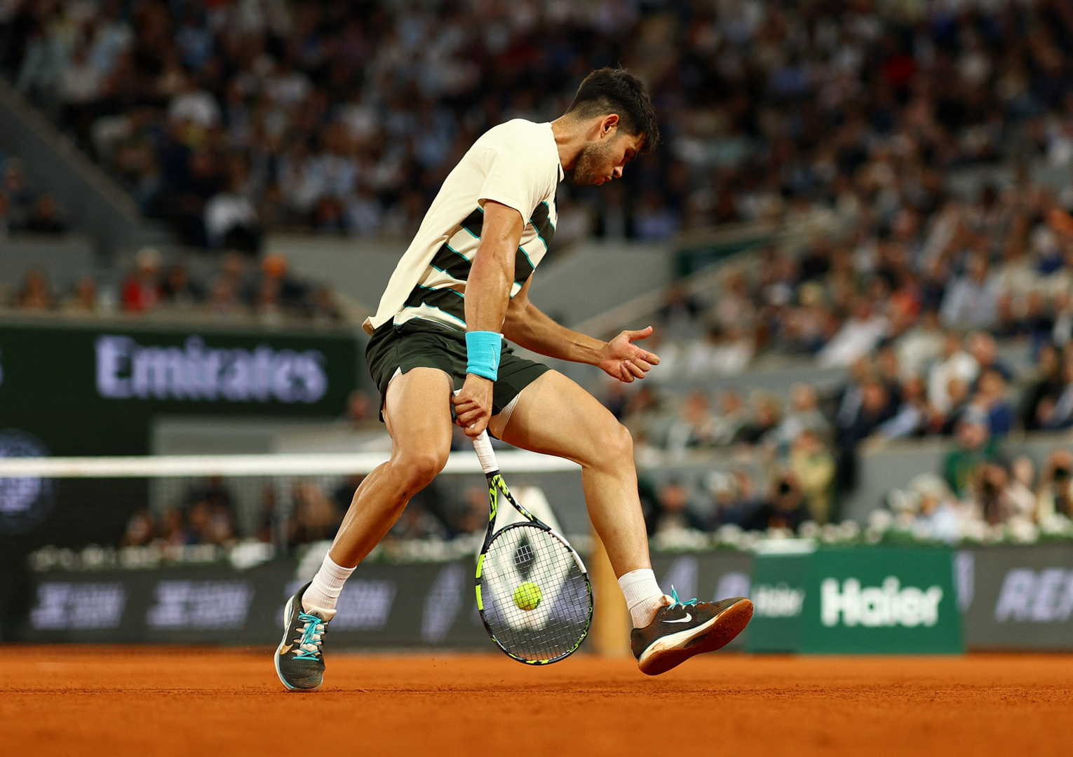 Carlos Alcaraz playing tennis at the French Open.