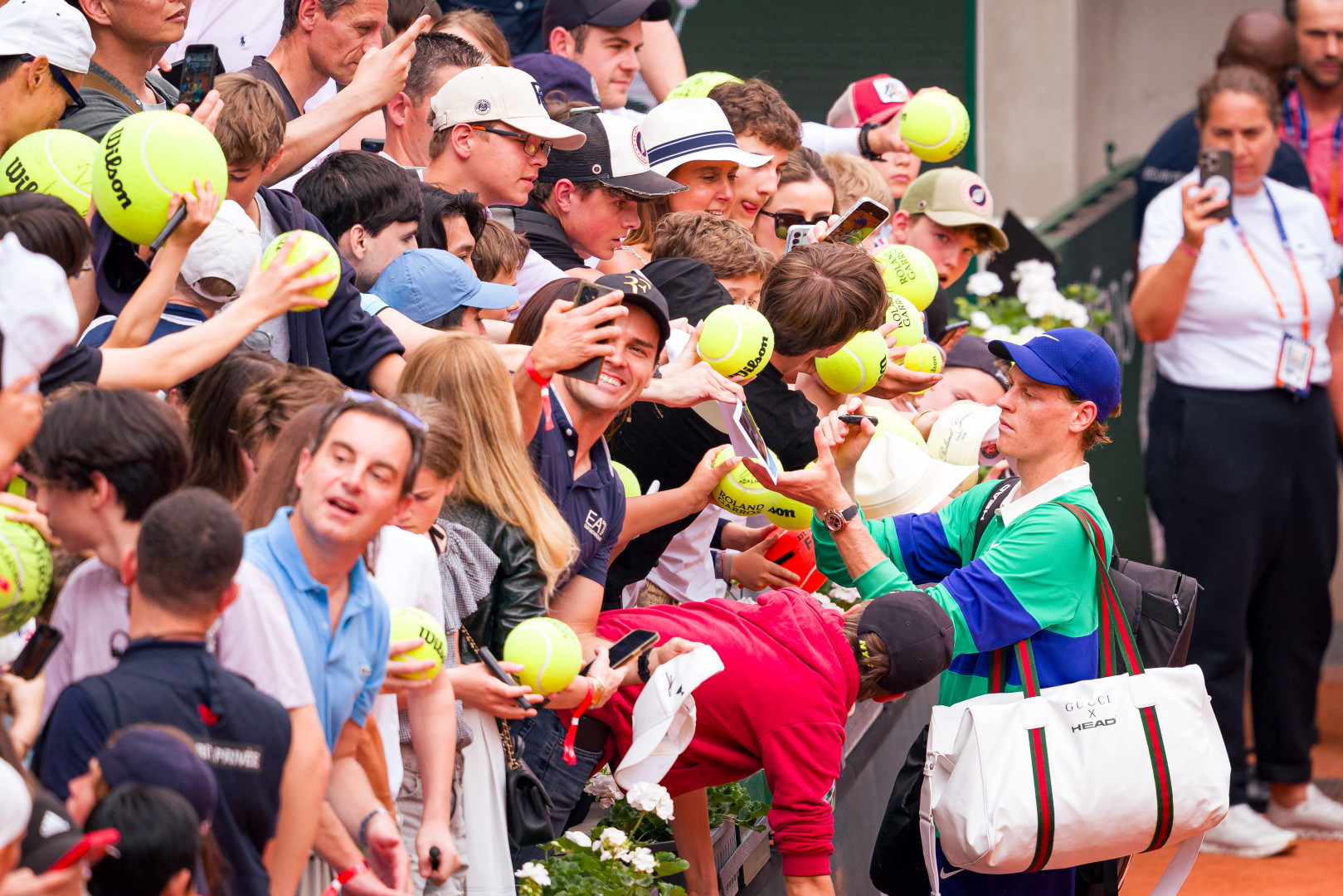 Declining interest in tennis among younger viewers, illustrated by Jannik Sinner signing autographs at Roland Garros.