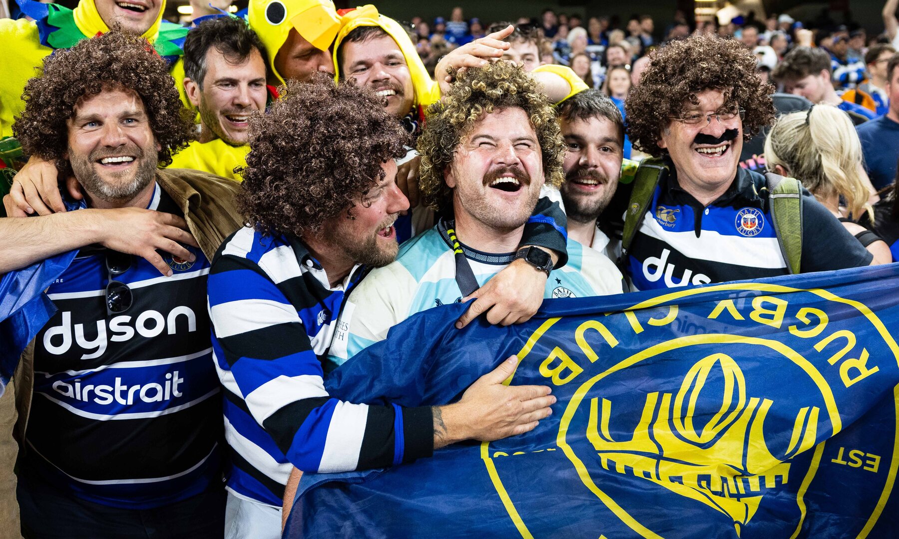 Bath Rugby fans celebrating after a rugby match.