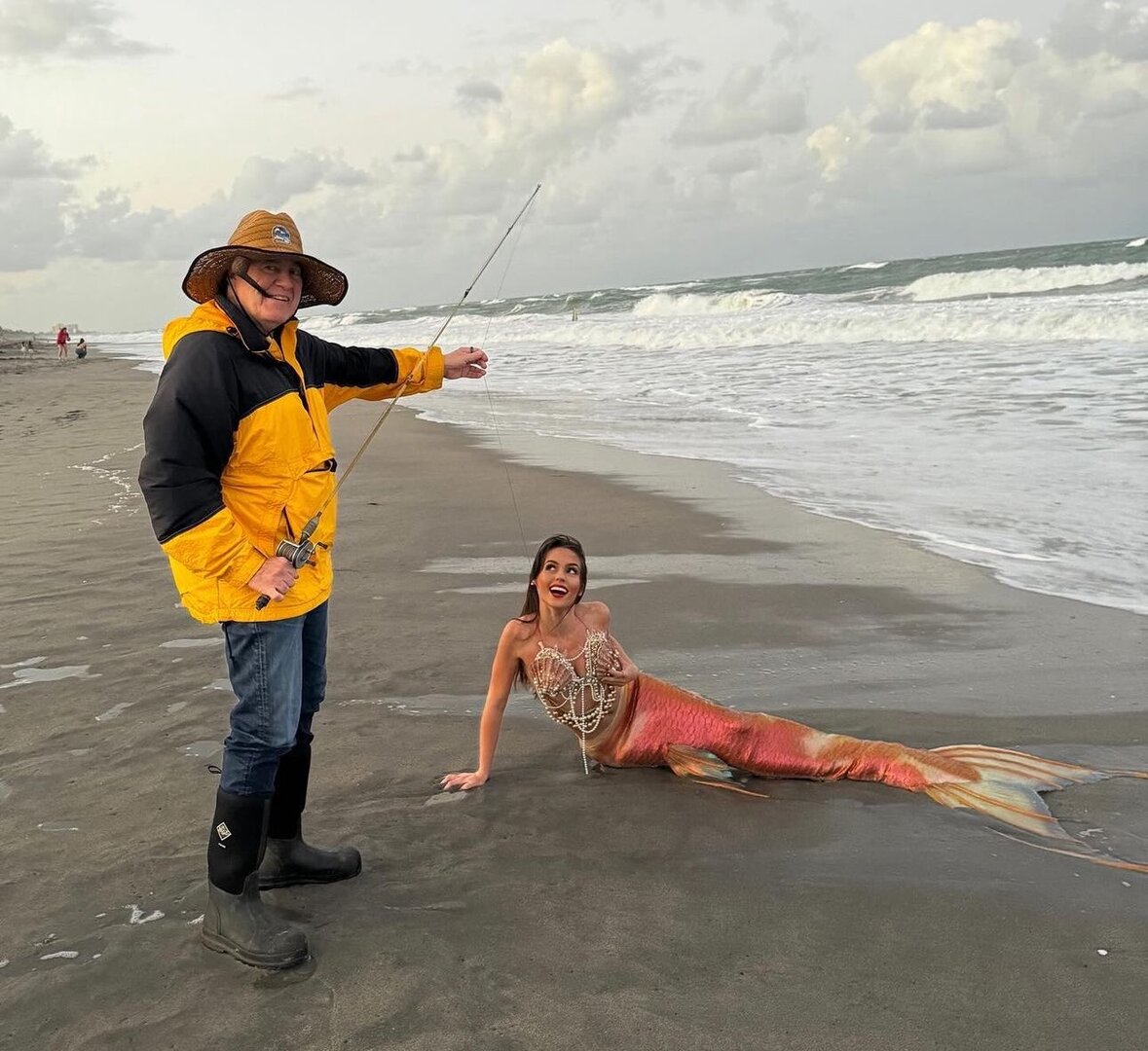 Bill Belichick and a mermaid on a beach.