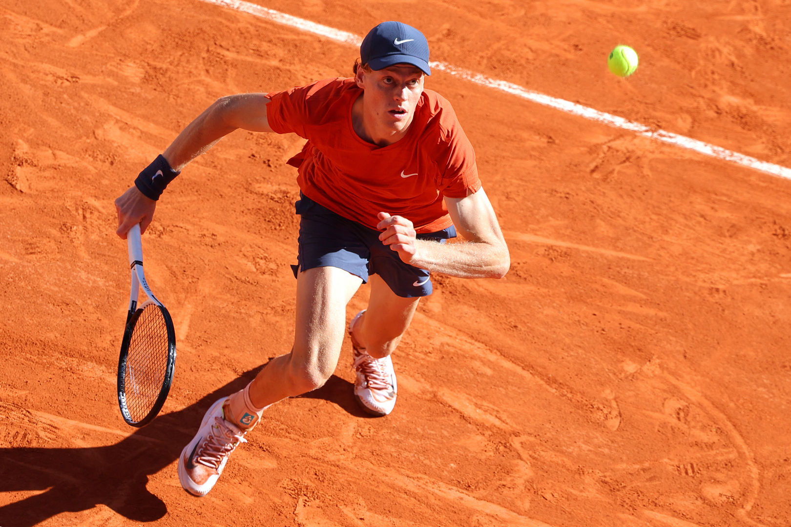 Jannik Sinner playing tennis at the French Open.
