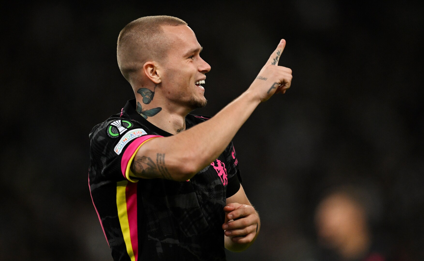 a man with a tattoo on his neck is pointing up